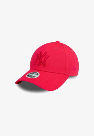 Red baseball cap with a curved brim, featuring an embroidered logo on the front and a reflective badge on the side. Textured fabric.