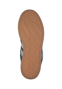 Grön och vit sneakersula med en texturerad gummibotten, med zigzag-mönster och präglad logotyp.