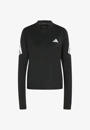 Camisa de manga larga negra con cremallera hecha de un tejido elástico, con acentos de rayas blancas en las mangas y un pequeño logotipo blanco en el pecho.