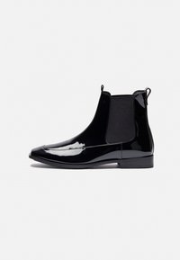 Black patent leather ankle boots with elastic side panels, pointed toe, and pull tabs for easy wear. Flat sole with minimal accent stitching.
