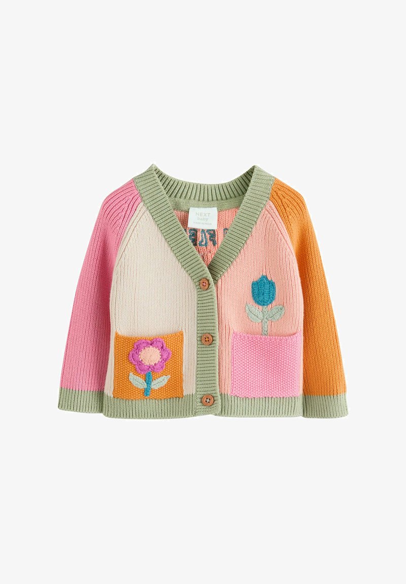 Baby cardigan with pink, cream, and orange sections, green trim, wooden buttons, and flower designs embroidered on front pockets.