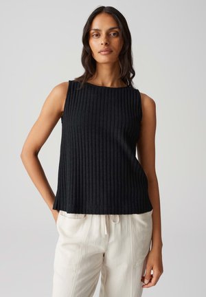 Zwarte ribbelige mouwloze top met een ronde halslijn, met een losse pasvorm en een gestructureerde stof. Gecombineerd met lichte, losse broeken.