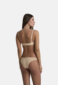 Set di bikini beige con reggiseno imbottito, spalline regolabili e chiusura a gancio, abbinato a uno slip a vita bassa. Texture liscia.