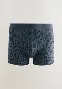 Navy blue boxer briefs with a black leopard print. Features a wide elastic waistband with the brand “NEXT” prominently displayed.