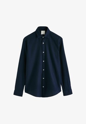 Marineblaues Langarmshirt aus stoff mit glatter textur. Hat eine Knopfleiste vorne, einen spitzen kragen und geknöpfte manschetten.