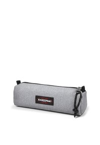 Grey pencil case made of textured fabric with a black zipper, featuring a prominent Eastpak logo patch on the side and a fabric loop.