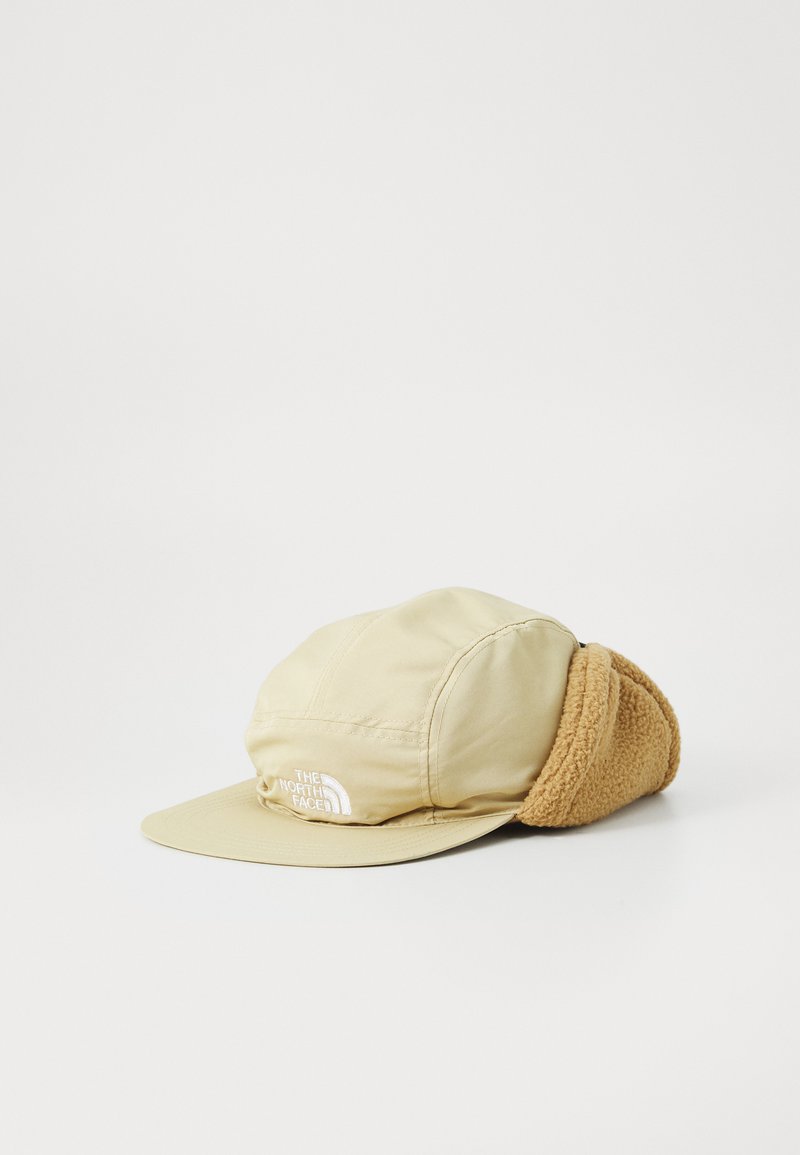 Beige cap with a soft, tan fleece ear flap. Features a flat brim and embroidered logo. Made from lightweight, smooth fabric.