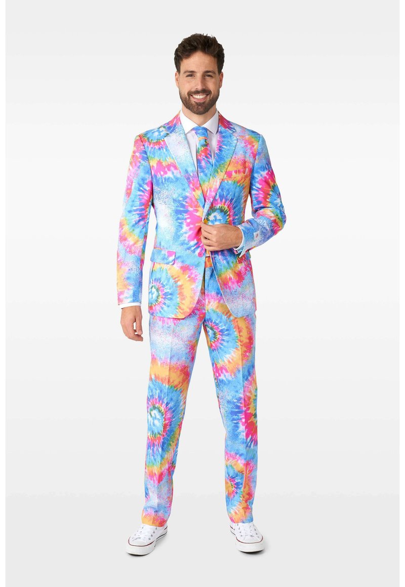 Colorful tie-dye suit featuring blue, pink, and yellow spiral patterns. Made of fabric with a smooth texture. Styled with a white dress shirt and tie.
