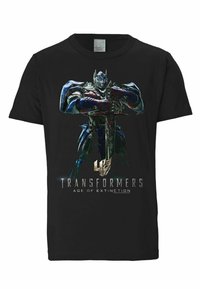 Black cotton t-shirt featuring a large graphic of a robotic figure with blue and silver accents, holding a sword, with "Transformers: Age of Extinction" text.