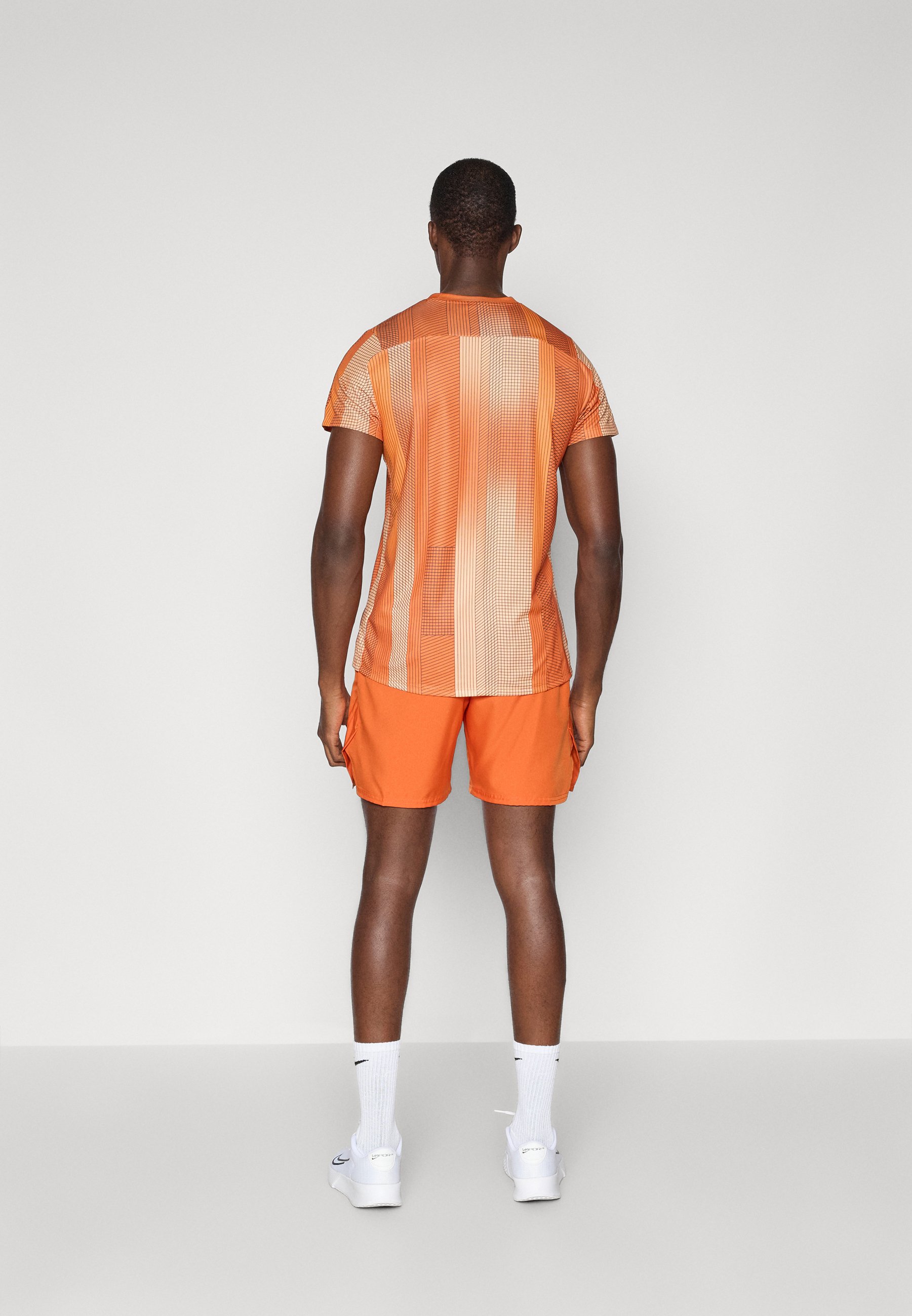orange and white nike shorts