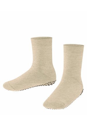 Beige Baumwollsocken mit gerippten Bündchen und strukturierten Sohlen, die kleine schwarze Grip-Punkte für verbesserten Halt aufweisen.