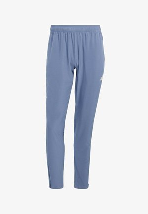 Blauwe sportbroek met elastische tailleband, taps toelopende pijpen en een subtiel logo op het bovenbeen tegen een witte achtergrond.