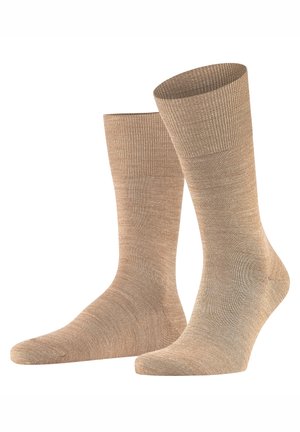 Beige socks with a ribbed cuff, smooth texture, and subtle sheen. Ankle-length design and seamless toe for comfort.
