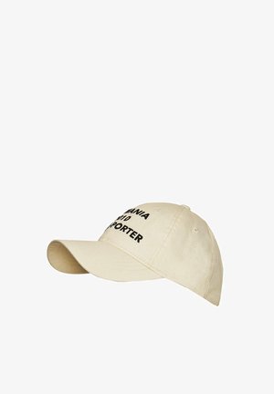 Šviesiai ruda medvilnės kepurė su išlenktu kraštu, ant priekinės dalies užrašyta didelėmis juodomis raidėmis "MANIA 10 REPORTER".