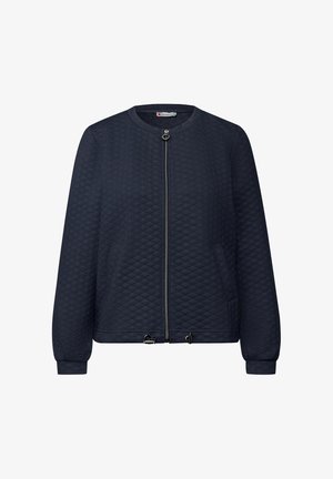 Laivastonsininen tikattu bomber-takki, jossa on pyöreä pääntie, etuvetoketju, sivutaskut sekä joustavat hihansuut ja helma. Varustettu hopeisilla metalliosilla.