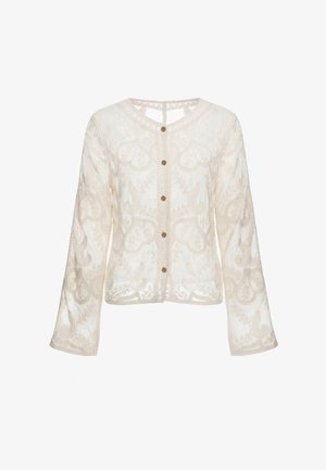 Langærmet, cremefarvet, gennemsigtig bluse med broderede blomsterdekorationer og fem brune knapper foran.