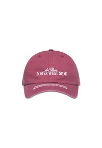 Maroon baseball cap made of cotton, featuring white embroidered text "Lower West Side." Curved brim and adjustable strap at the back.
