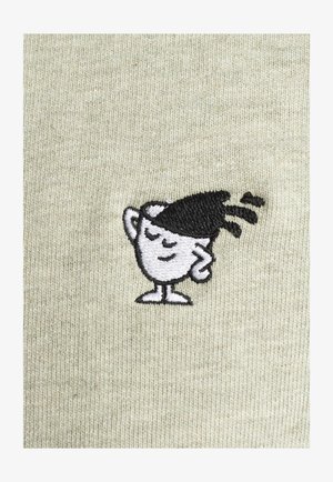 Embroidered patch of a smiling cartoon cup with a black hairstyle, on a light green textured fabric background.