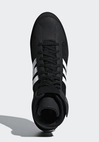 Black high-top sneaker made of textured leather and mesh, featuring three white stripes, round toe, and lace-up closure.