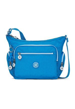 Sac à bandoulière bleu vif avec plusieurs poches zippées, un petit logo à l'avant, et un porte-clés singe bleu assorti attaché.