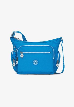 Sac à bandoulière bleu vif avec plusieurs poches zippées, un petit logo à l'avant, et un porte-clés singe bleu assorti attaché.