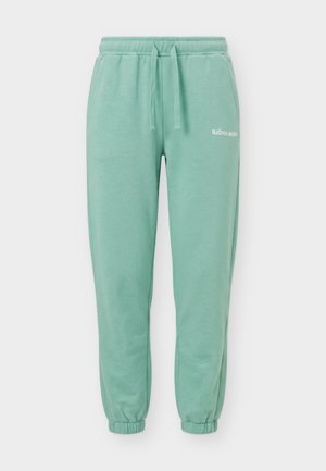 Pantalon de jogging vert clair avec poignets élastiques, taille à cordon, poches latérales et petit logo blanc "BJÖRN BORG" sur la cuisse gauche.