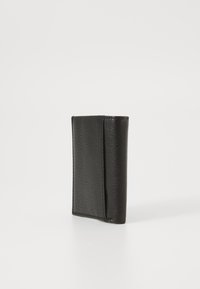 Black leather wallet with a textured finish, rectangular shape, and minimal design. Features a single folded compartment for cards.