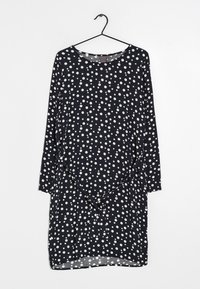 Sukně s puntíky v námořnické modři s bílými tečkami. Dlouhé rukávy, kulatý výstřih, uvolněný střih, nařasený detail v pase, lehká tkanina.