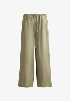 Light olive green, wide-leg pants made of textured fabric, featuring an elastic waistband with a drawstring for adjustable fit.