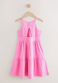 Różowa sukienka bez rękawów z teksturowanej tkaniny, z zapięciem na guziki z tyłu oraz rozkloszowaną spódnicą z dwoma warstwami.