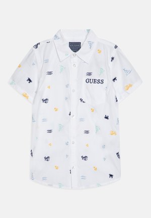 Camicia bianca a maniche corte con ricami nautici multicolore, dotata di colletto a pieghe e taschino sul petto.