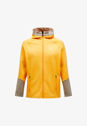 Gul sportsjakke med lynlås fortil, grå ærmer og høj krave med "PEACE" i hvid. To sidelommer og en glat tekstur.