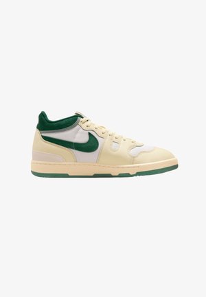 High-top sneaker in beige, with green accents. Features a mesh and leather upper, round toe, and a textured rubber sole.