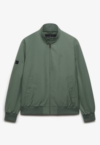 Veste légère de couleur vert olive avec col montant, fermeture éclair frontale, poignets élastiques, deux poches latérales et écusson logo sur la manche. Texture lisse.