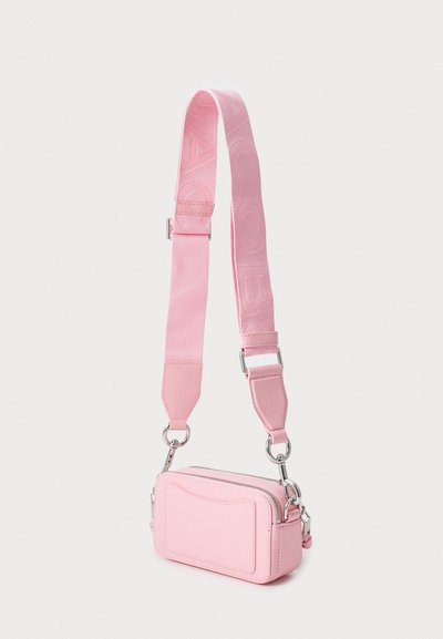 Pink crossbody bag made of smooth material, with a rectangular shape, zip closure, and a textured strap featuring logo accent. Silver hardware details.