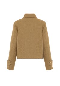 Giacca beige texturizzata tagliata con colletto, maniche lunghe e polsini abbottonati. Il tessuto presenta un motivo tessuto e una lucentezza sottile.