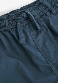Dunkelblaue Shorts mit elastischem Bund, Kordelzug und genähten Details. Glatte Stoffoberfläche mit funktionalem Design für Komfort.