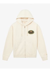 Roomkleurige hoodie met ritssluiting, een voorzak, trekkoorden en een groen geborduurd embleem met een boom en tekst. Gemaakt van zacht katoen.