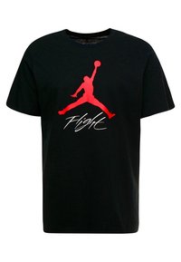 Černé bavlněné tričko s velkým červeným logem Jumpman a bílým nápisem "Flight" napsaným skriptovým písmem na přední straně. Krátké rukávy, kulatý výstřih.