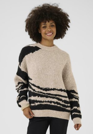 Pull beige avec des rayures abstraites noires et crème, en fil moelleux, doté d'un col rond et de manches longues à coupe décontractée.