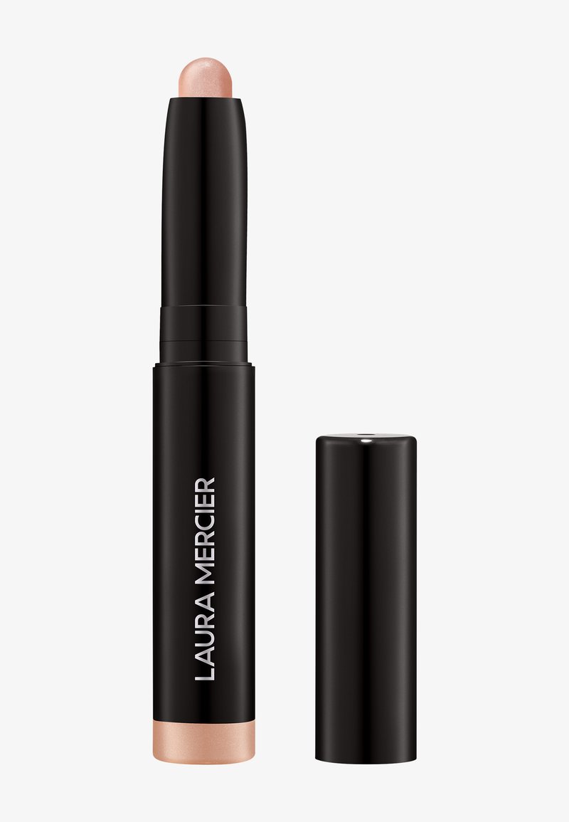 Laura Mercier highlighterstick in een zwarte cilindrische tube met een goud-roze punt; gladde textuur, draaimechanisme en zwarte dop.