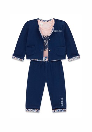 Navy tracksuit featuring a button-up jacket with two pockets and floral cuffs, paired with matching pants. Pink shirt with heart graphic inside.