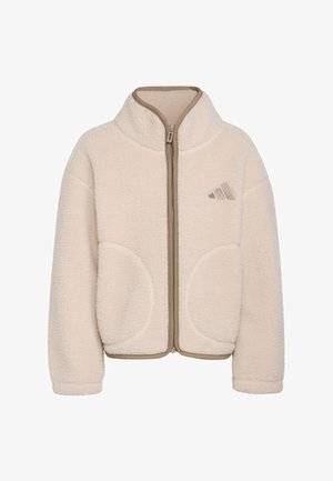 Veste polaire couleur crème avec fermeture éclair intégrale devant, col haut, poches latérales arrondies et logo discret sur la poitrine gauche.