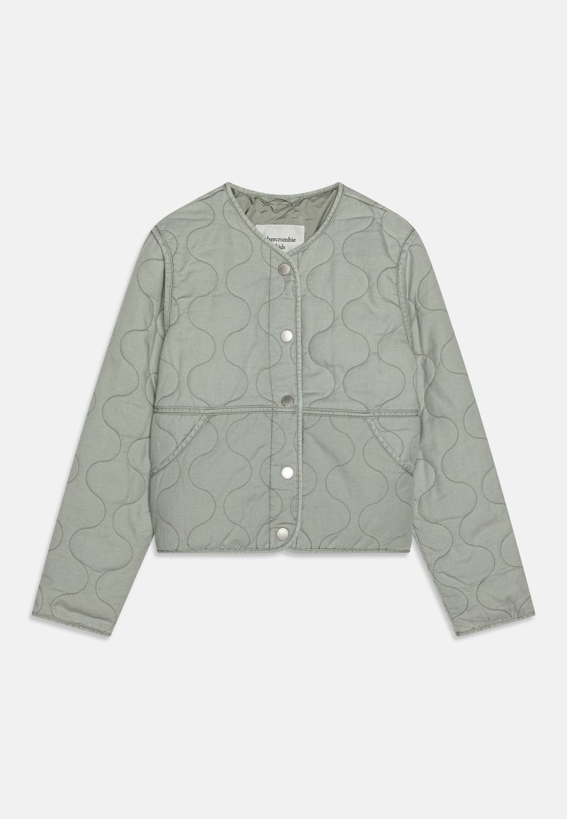 Kurtka pikowana w jasnym zielonym kolorze, z zapięciem na guziki, okrągłym dekoltem i przeszyciem w falisty wzór. Miękka tkanina z długimi rękawami.