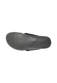 Σόλα μαύρου σανδαλιού τύπου slip-on με υφή αντιολισθητικού μοτίβου και το όνομα της μάρκας "Wojas" ανάγλυφο στο κέντρο.
