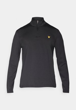 Black long-sleeve pullover with a high zip collar. Features a small yellow eagle logo on the left chest. Smooth fabric texture.