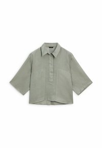 Light green linen shirt with a collared neckline, front button placket, short sleeves, and two chest pockets. Square fit with subtle texture.