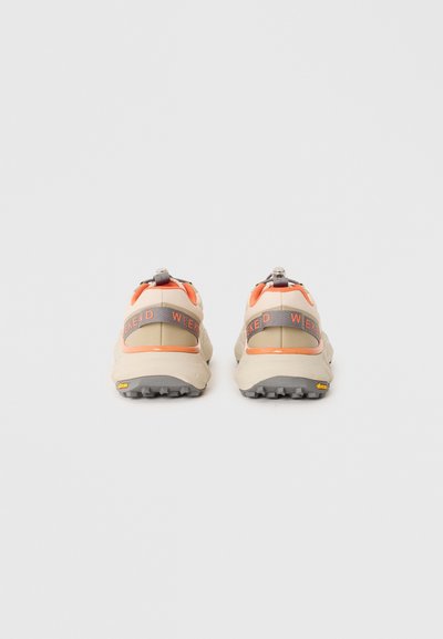 Sport shoes featuring a beige and orange textile upper, with grey accents and a textured, grippy outsole. "WEEKEND" printed on the back.