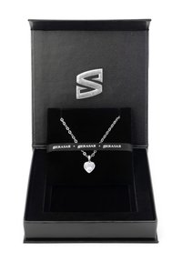 Silver chain necklace with a heart-shaped clear crystal pendant, presented in a black leather box with a black velvet interior and branding.