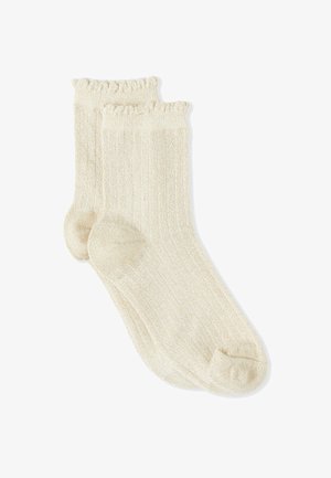 Cremefarbene, gerippte Baumwollsocken mit gerüschtem oberen Rand und verstärkter Spitze. Weiche Textur und leichtes Design.